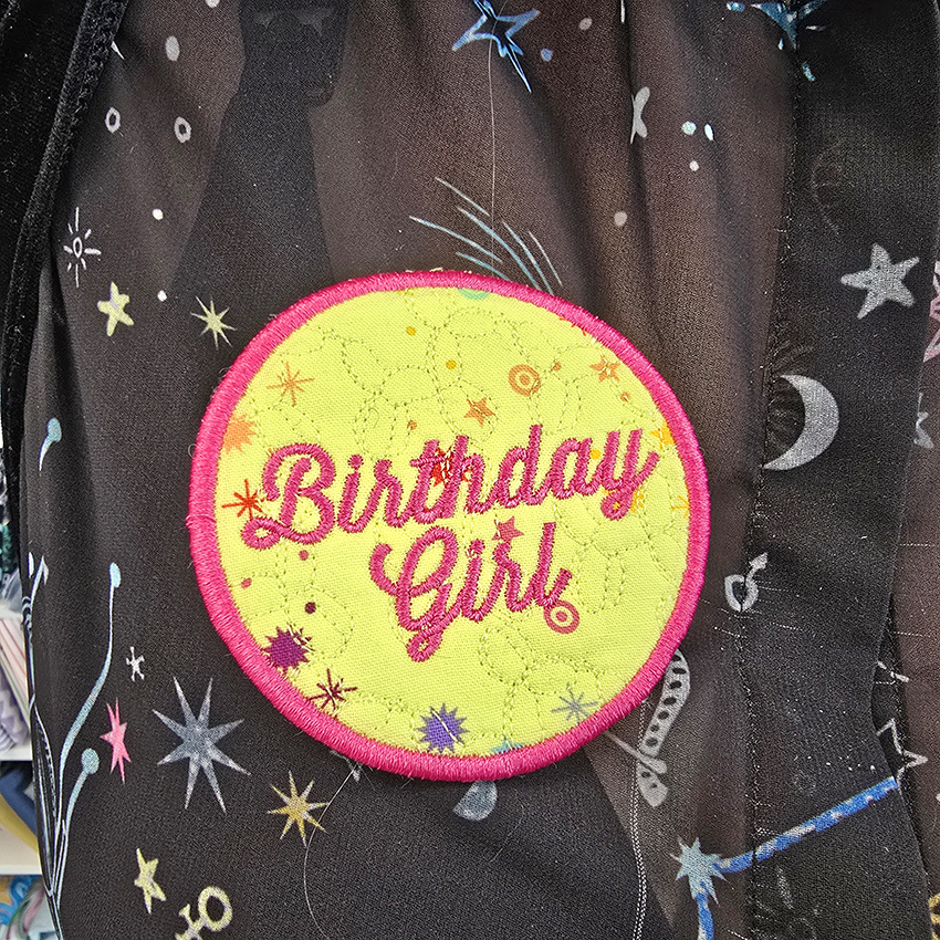 ITH patch with 'Birthday Girl' text worn