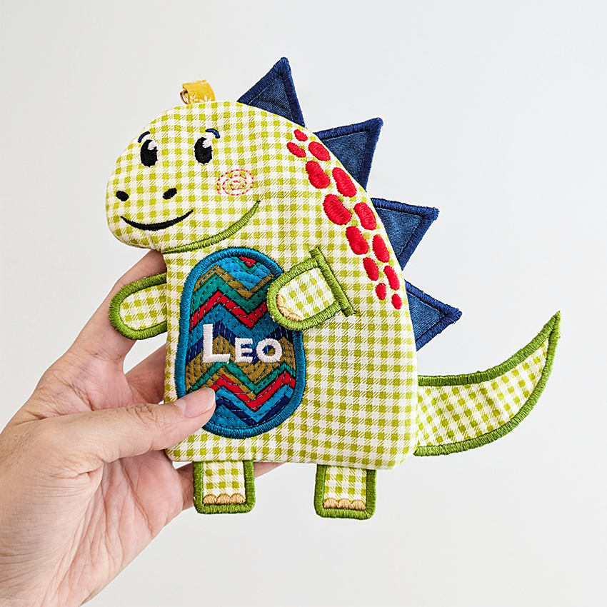 green dinosaur purse with blue spikes and custom text on belly in bigger size