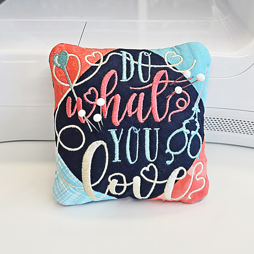 Decorative pillow with 'Do what you love' text on a white background