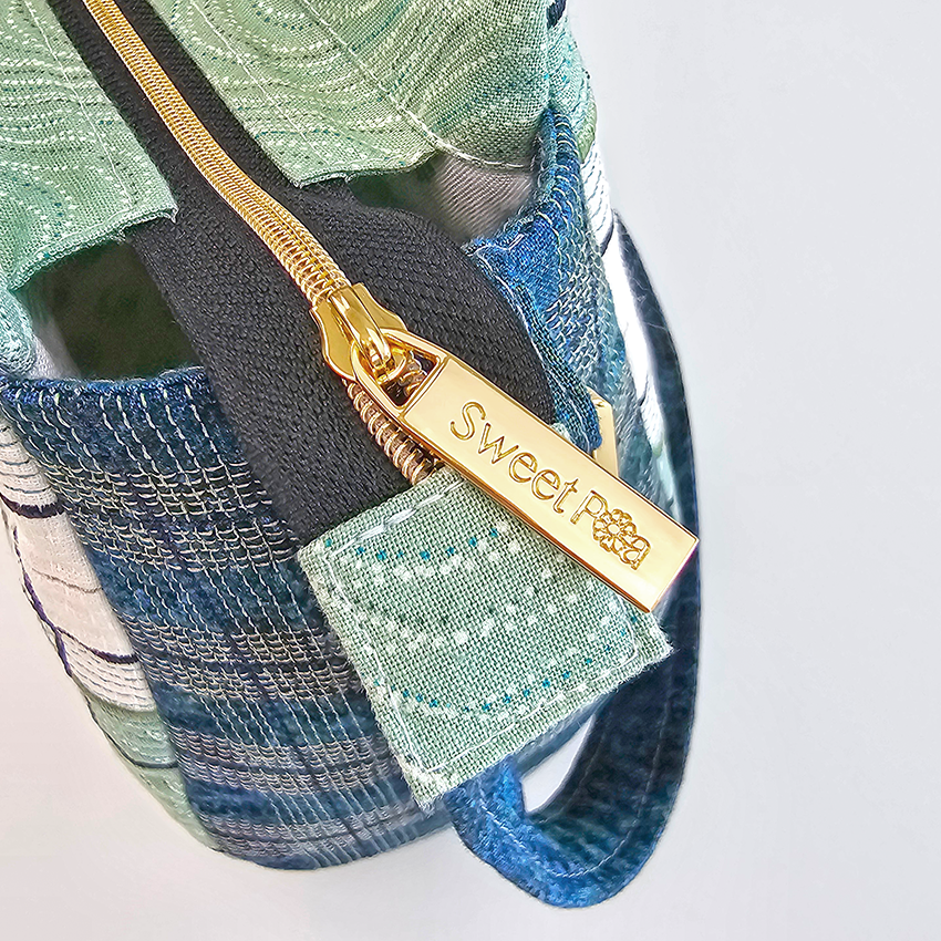 down town tote bag embroidery design with gold sweet pea zip close up