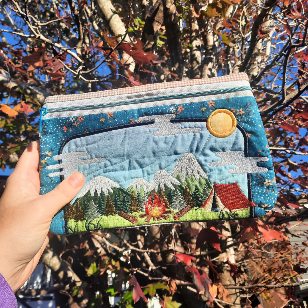 Camping Scene Zipper Case with winter tree behind it