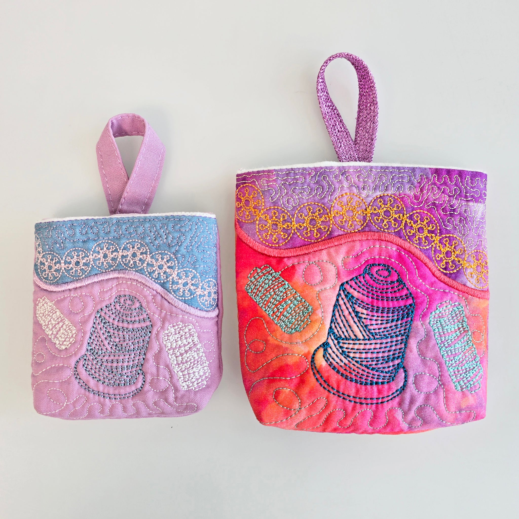 Two small quilted fabric thread catchers, displayed side by side