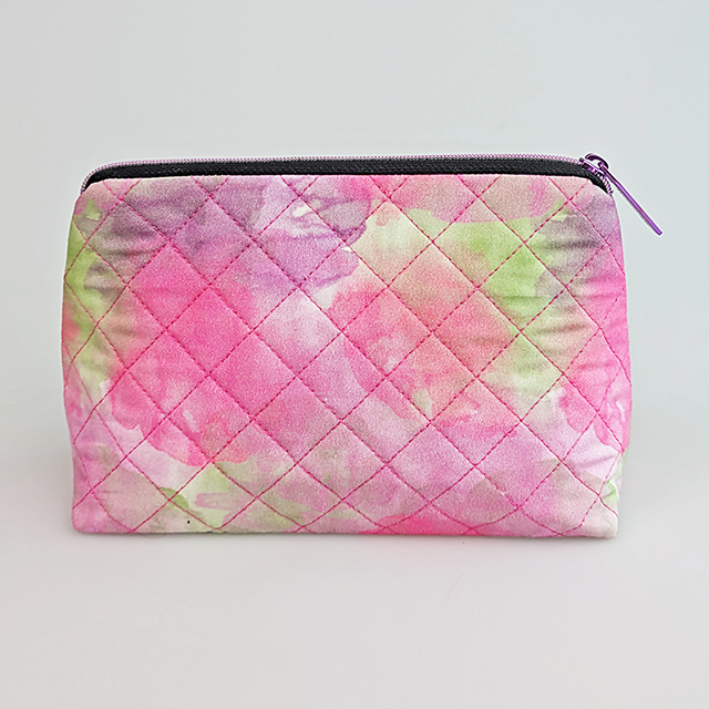 Quilted makeup bag with pink and green tie-dye pattern made ith by sweet pea