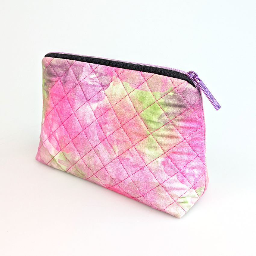 purple zipper closed on quilted purse