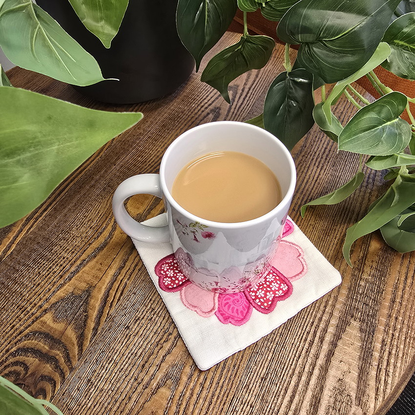 mug on top of sweet pea flower coaster