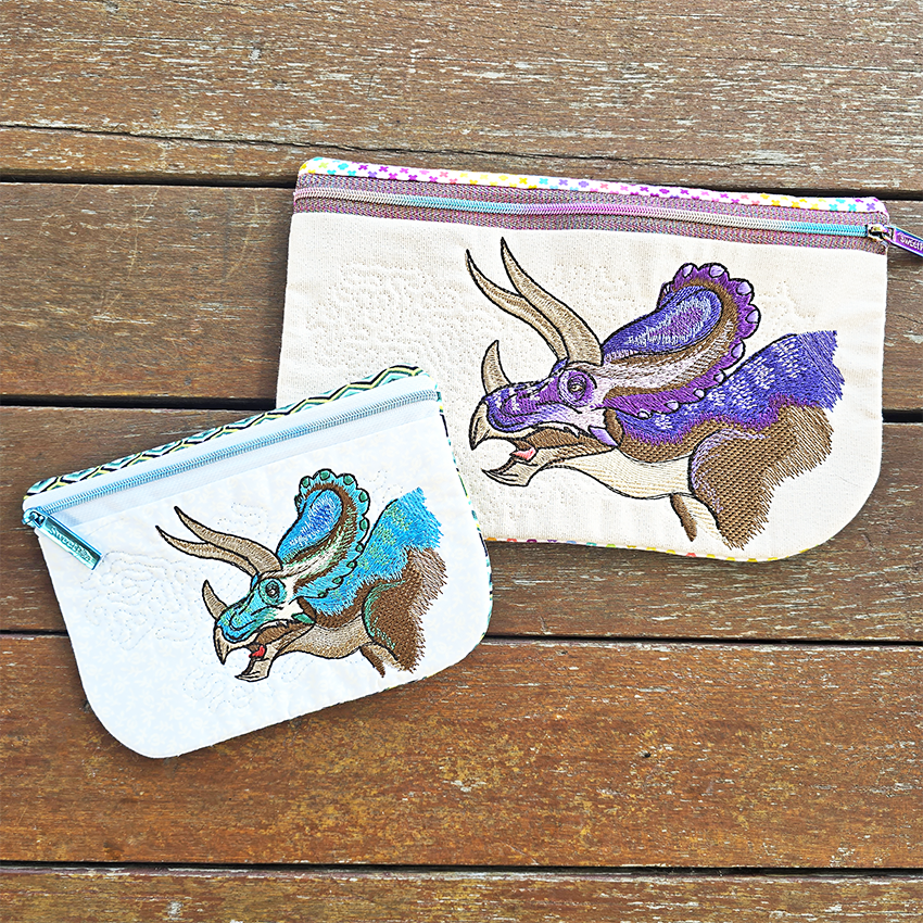 Two pouches with dinosaur designs made ith