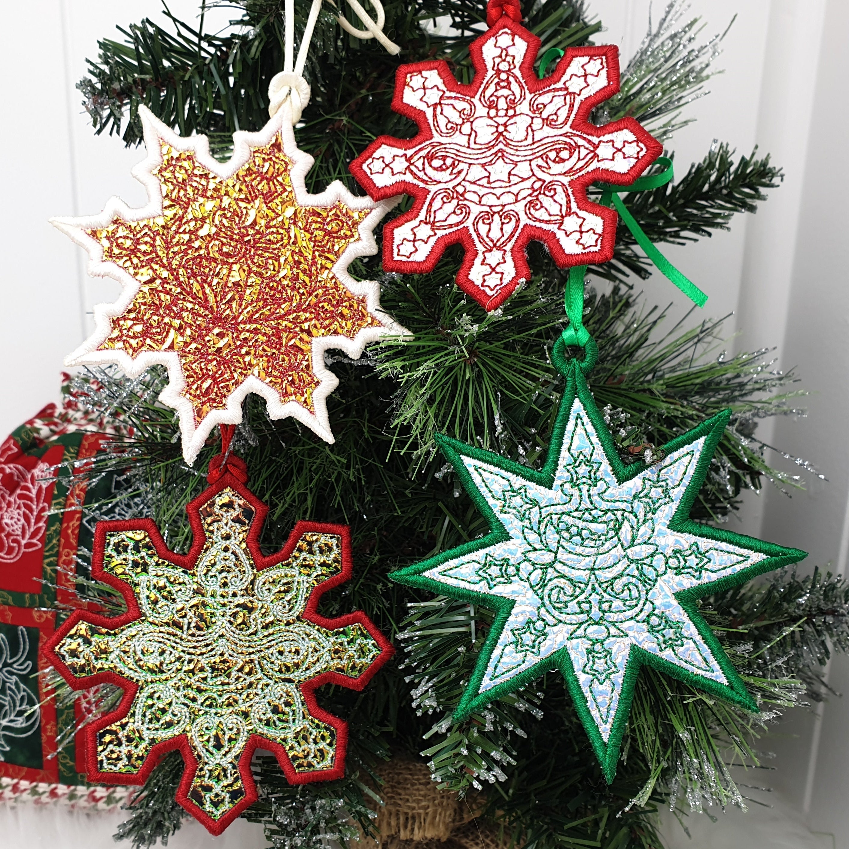 Mylar ITH Christmas ornaments on a tree with a white background