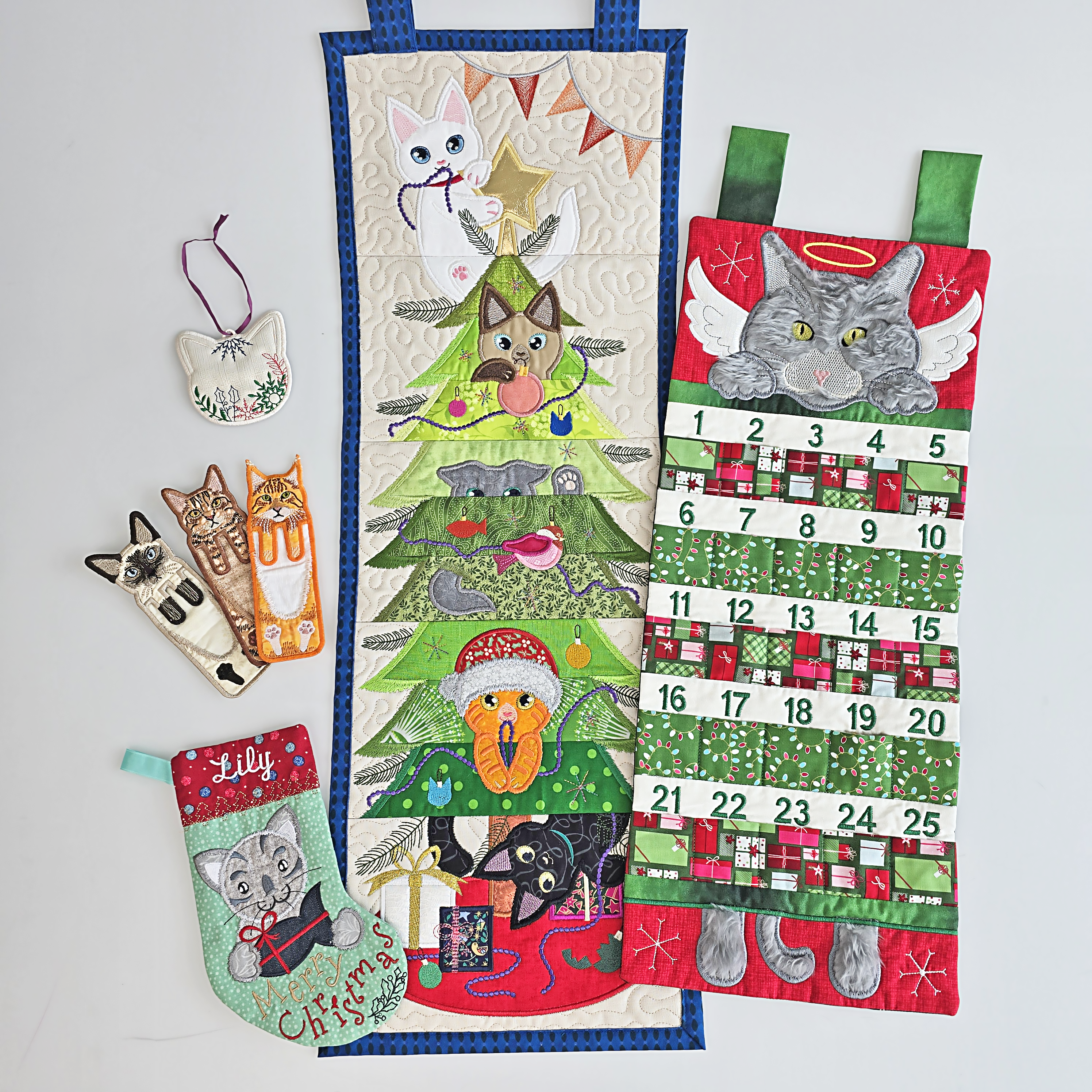 Set of Christmas-themed cat decorations made ITH including a calendar, tree, and stockings