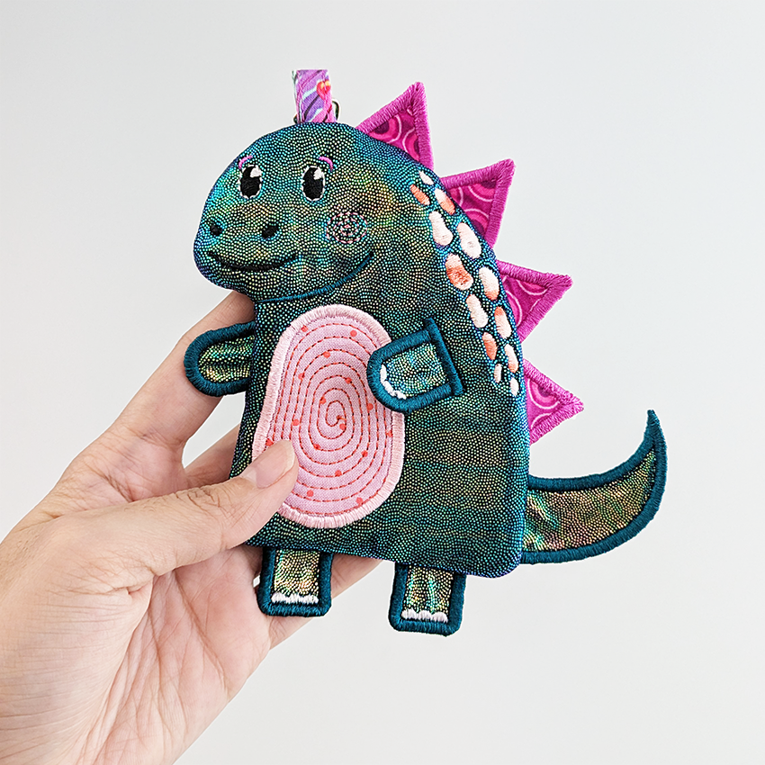 shiny dinosaur purse with pink spikes in smaller size