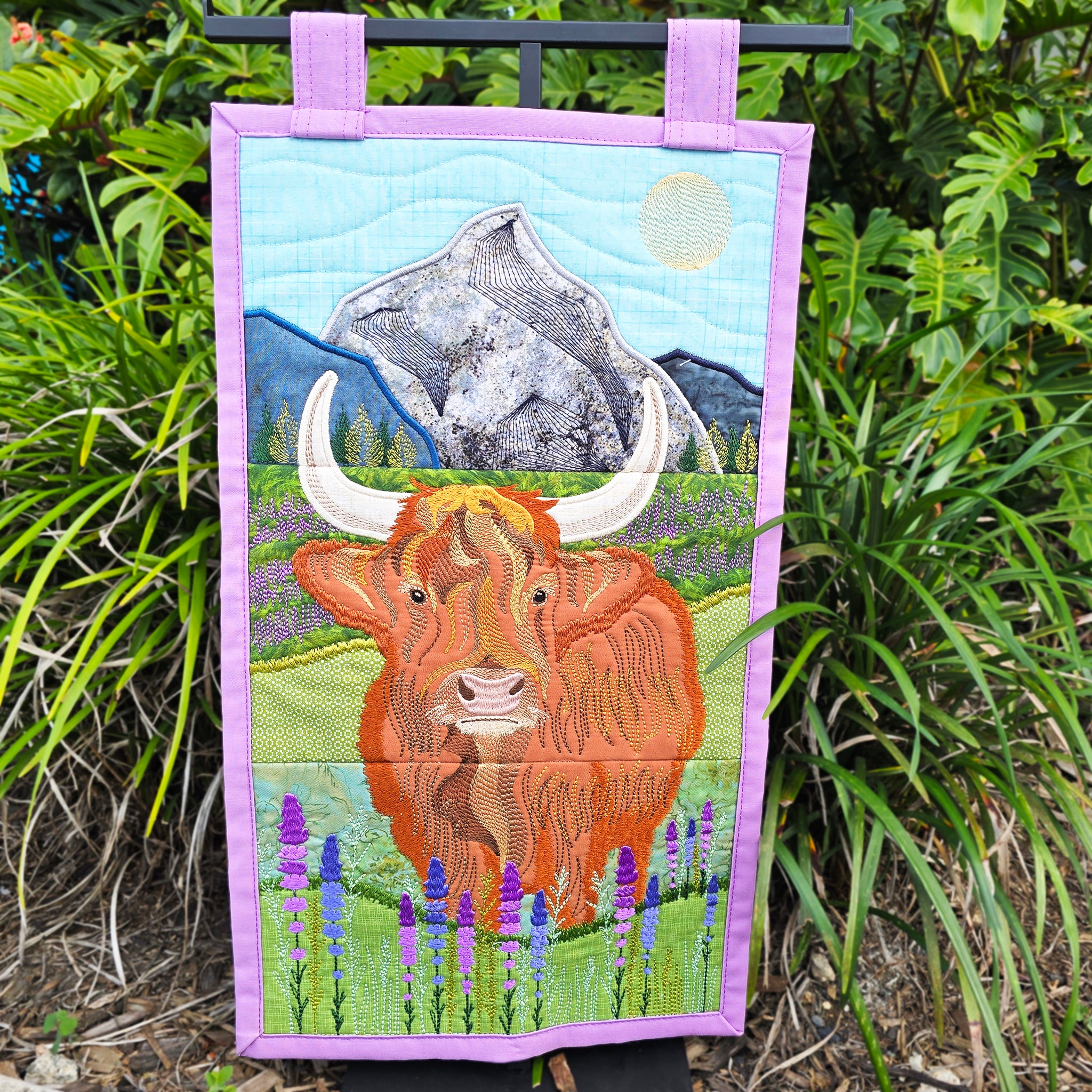 Highland Cow Hanger in the grass