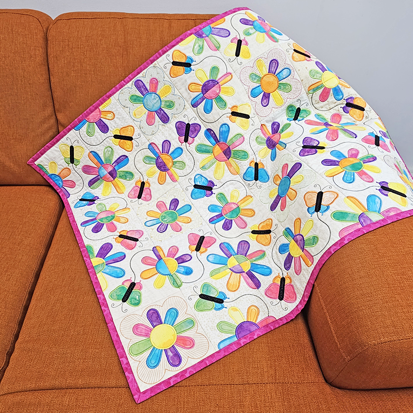 Summers Day Quilt ith design on couch