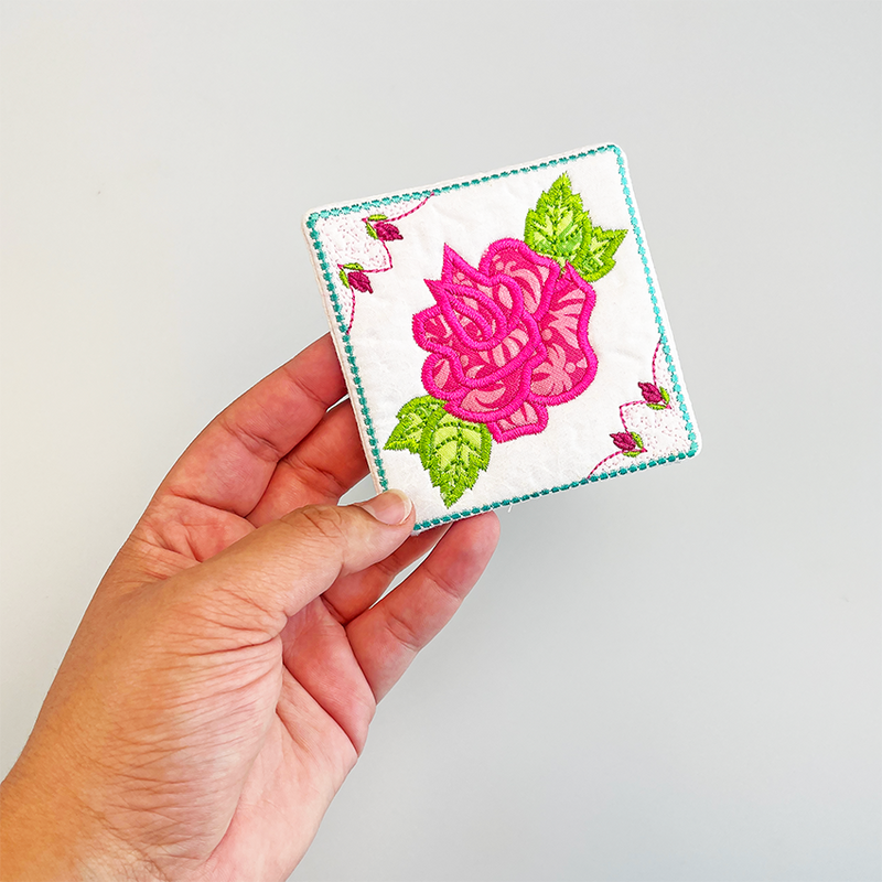 machine embroidered rose coaster in hand